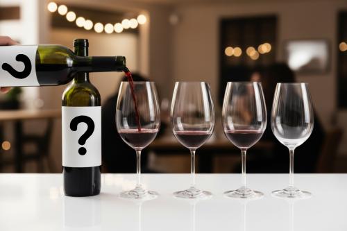 4 glasses of wine with two white labels with question marks for a blind tasting 4 glasses of wine with two white labels with question marks for a blind tasting