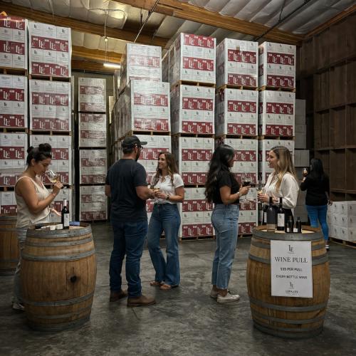People standing in front of cases of wine - Wine Pull warehouse wine sale