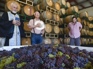 Photo by Len Wood of Father John Finley blessing the first fruits of the Lucas & Lewellen grape harvest