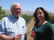 Louis Lucas and Megan McGrath Gates with wine in a vineyard
